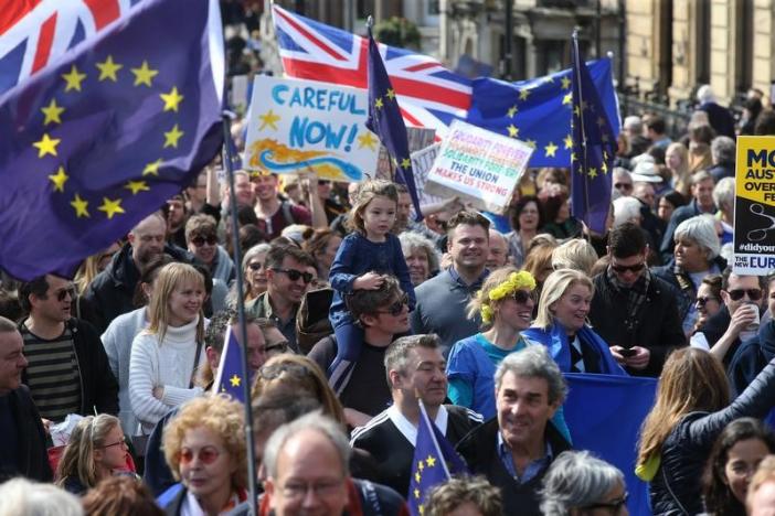 Demonstrators take part in a Unite for Europe march, as they head towards Parliament Square, in central London