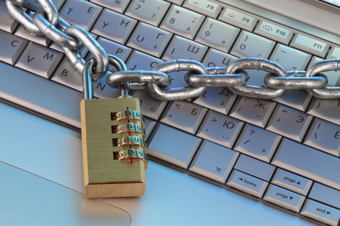 chain and digital padlock on computer keyboard