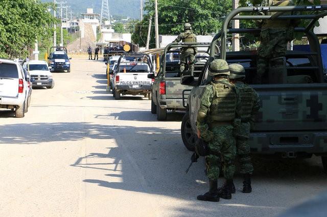 Soldiers stand outside a prison after a riot broke out at the maximum security wing in Acapulco