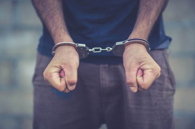 arrested-man-handcuffed-hands-back_2919-240