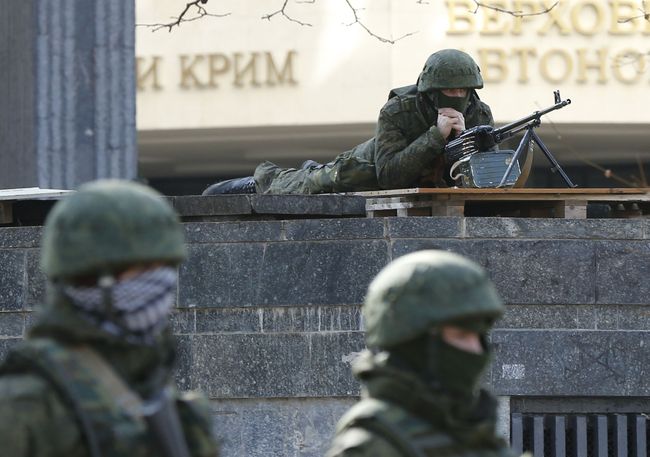 Armed men take up positions around the regional parliament building in the Crimean city of Simferopol