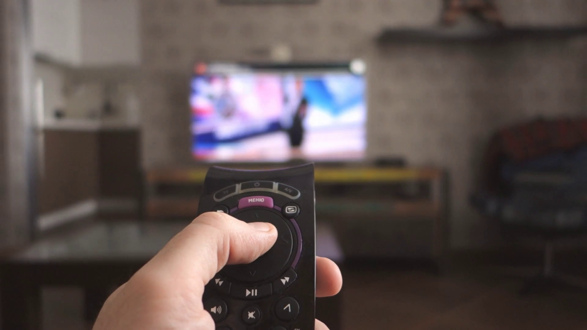 videoblocks-male-hand-holding-the-tv-remote-control-and-turn-off-smart-tv-channel-surfing-focused-on-the-hand-and-remote-control-internet-tv_bgzrxmgeie_thumbnail-full01