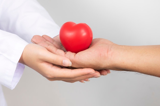 close-up-image-doctor-s-hand-holding-hands-with-heart-hands_36755-403