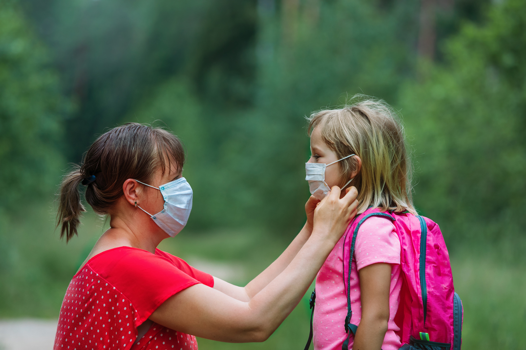 mother and child with masks going to school