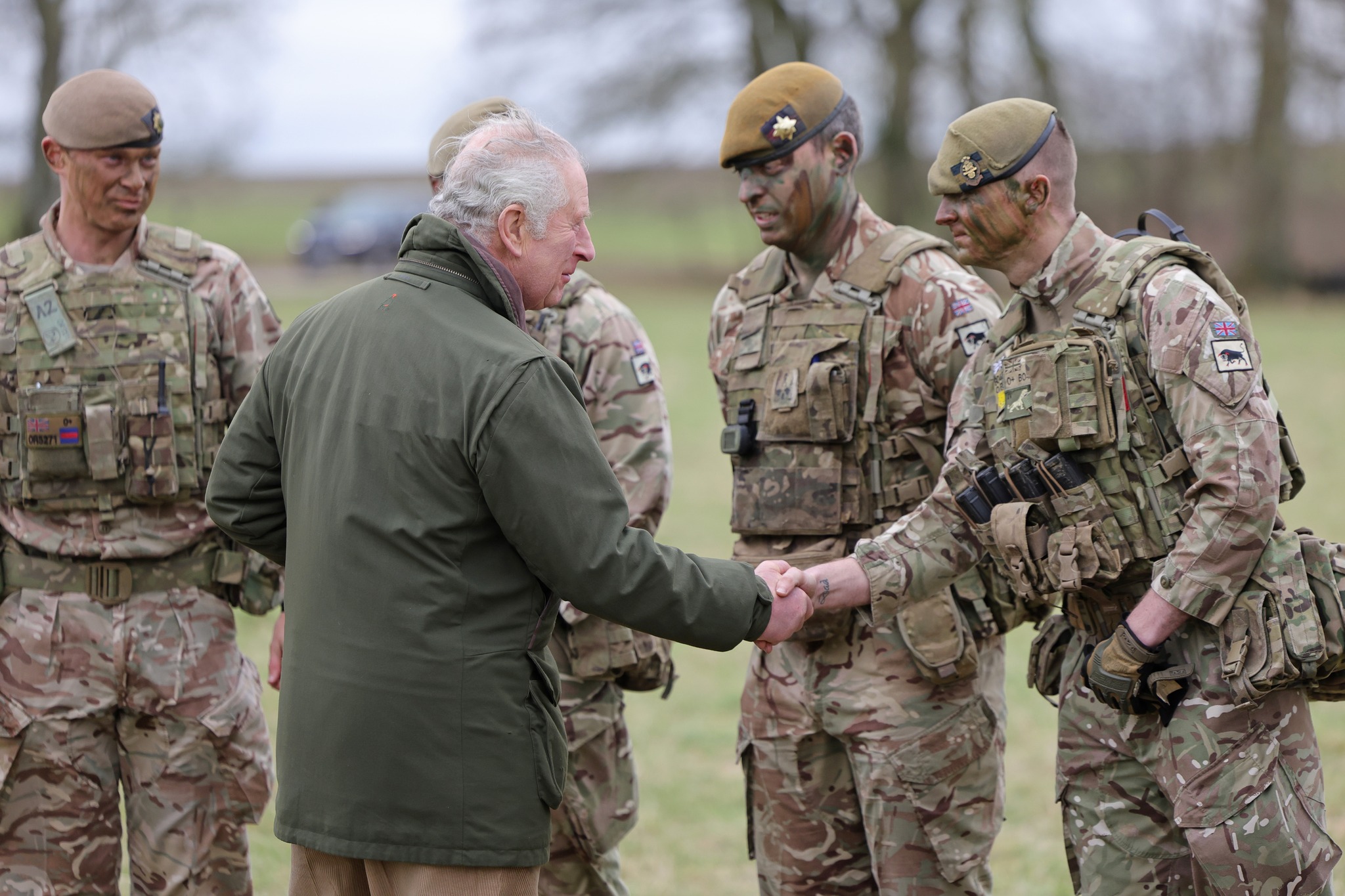 King Charles III meets Ukrainian recruits during a visit to a training site for Ukrainian military, in Wiltshire, where recruits are completing five weeks of basic combat training by British and international partner forces, before returning to fight in Ukraine. Picture date: Monday February 20, 2023.