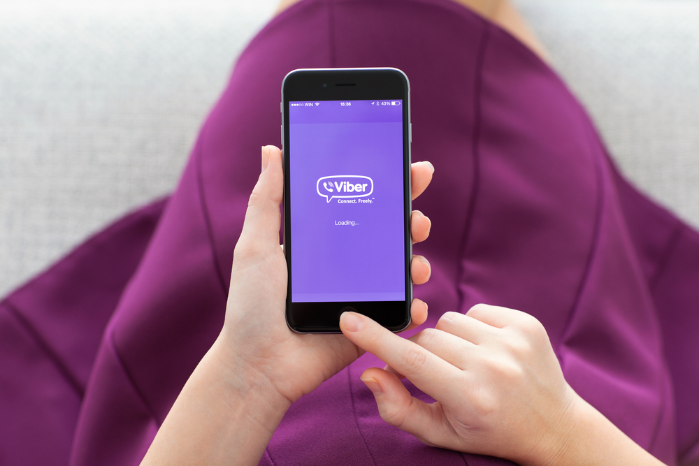 Woman holding iPhone 6 with Viber on the screen