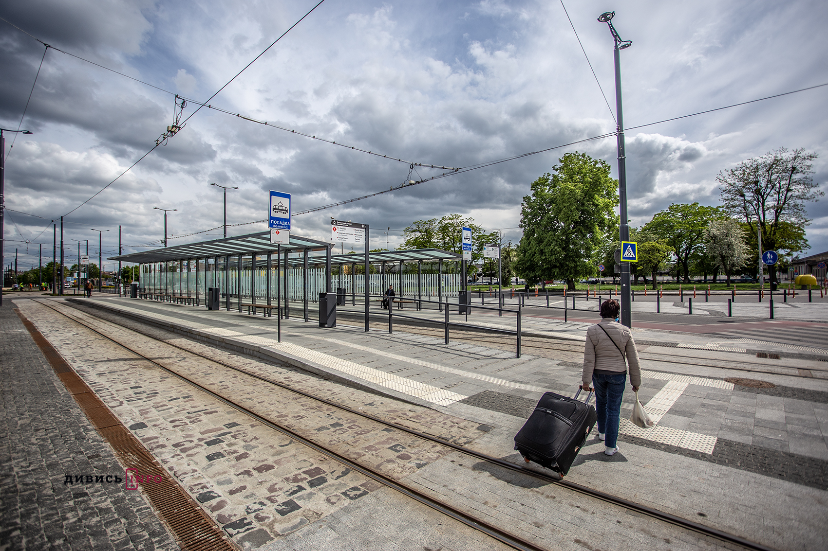 a person with luggage walking on a train track