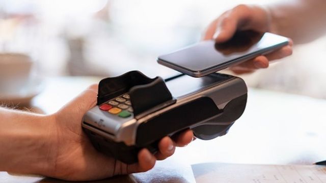 a person holding a phone and a device